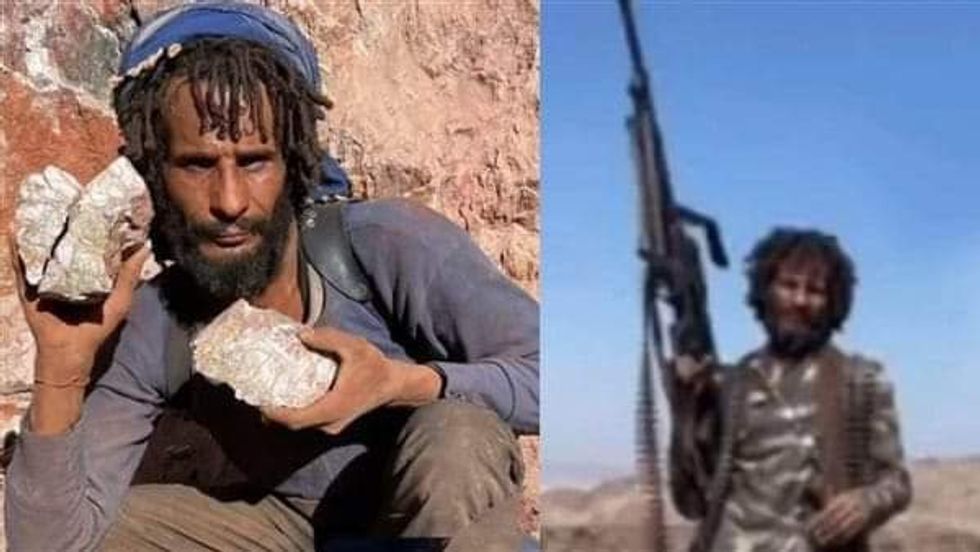 Photo of a man holding stones and a gun.
