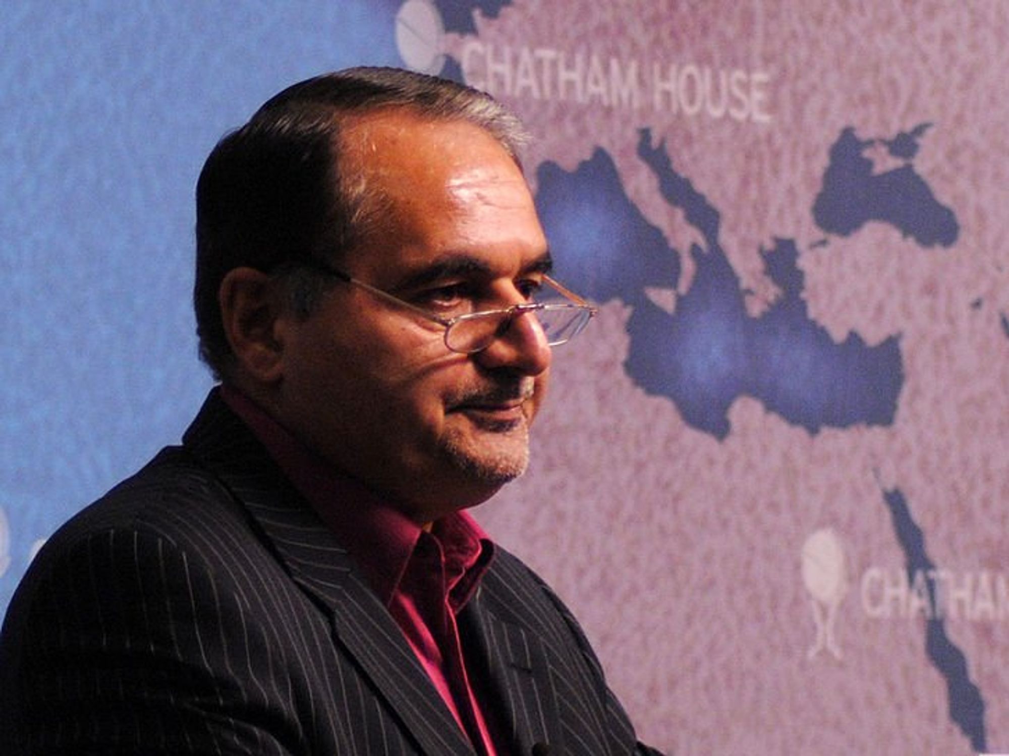 photo of a man in front of a map