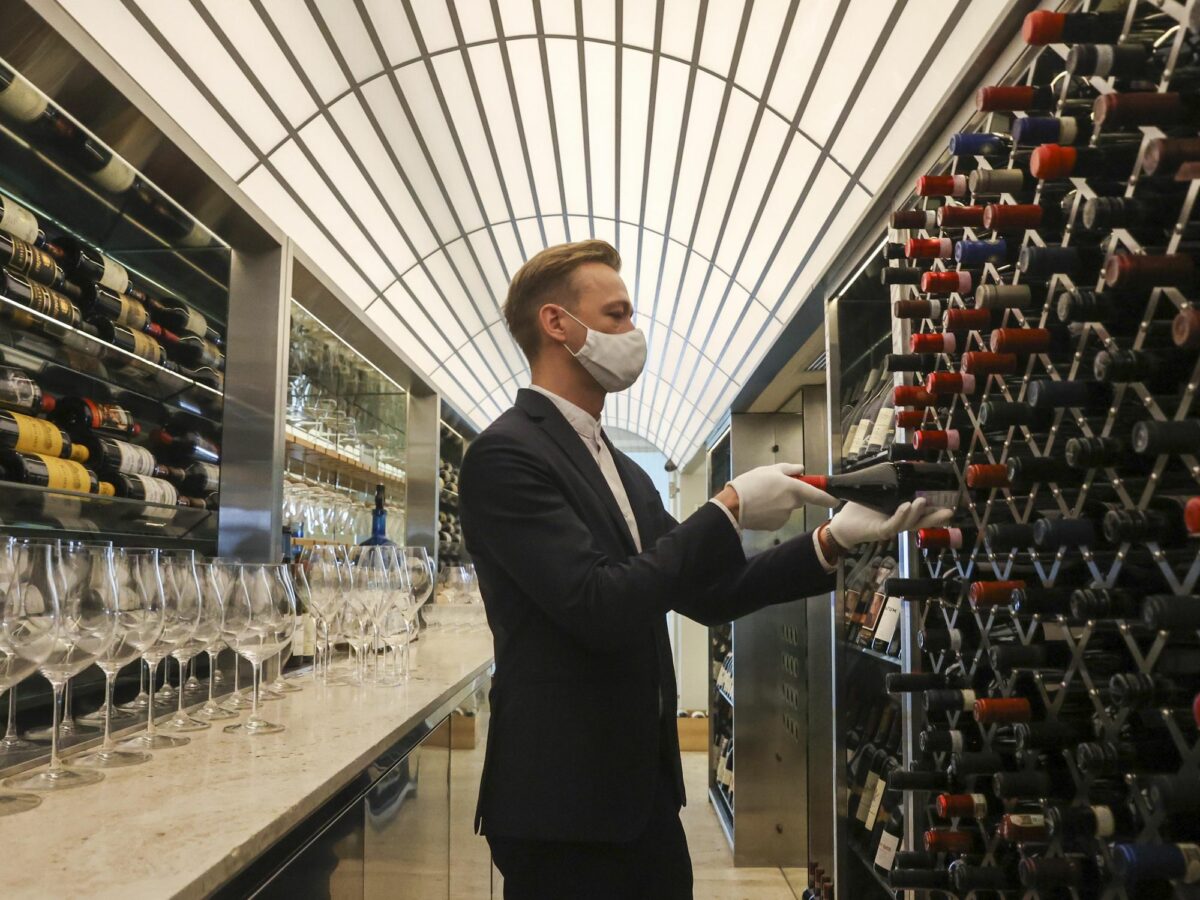 Photo of a man in front of wine cellar