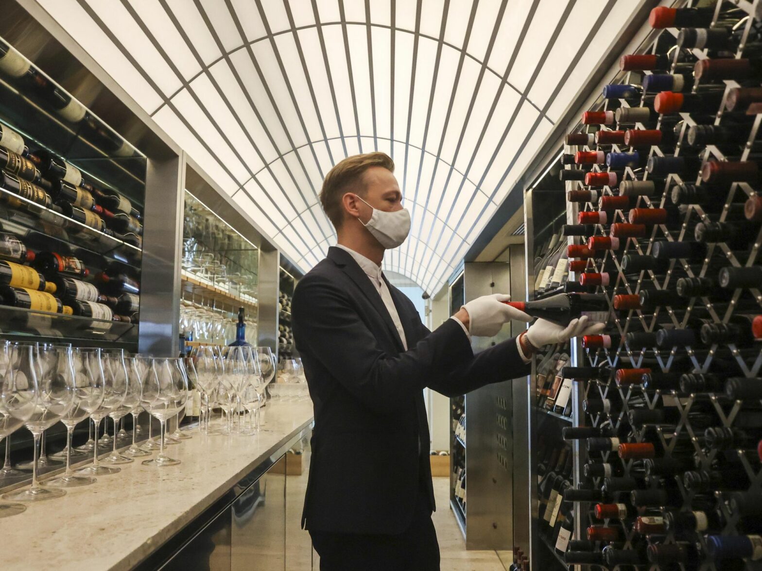 Photo of a man in front of wine cellar
