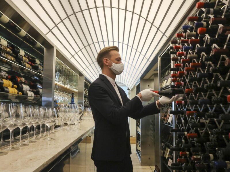 Photo of a man in front of wine cellar