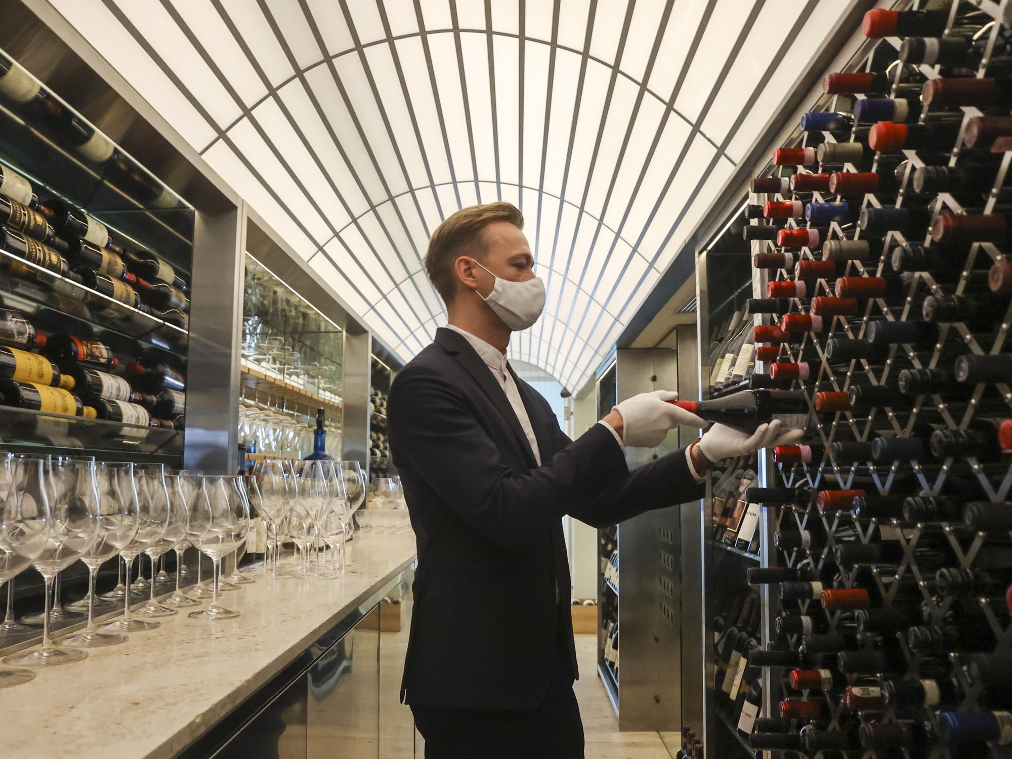 Photo of a man in front of wine cellar