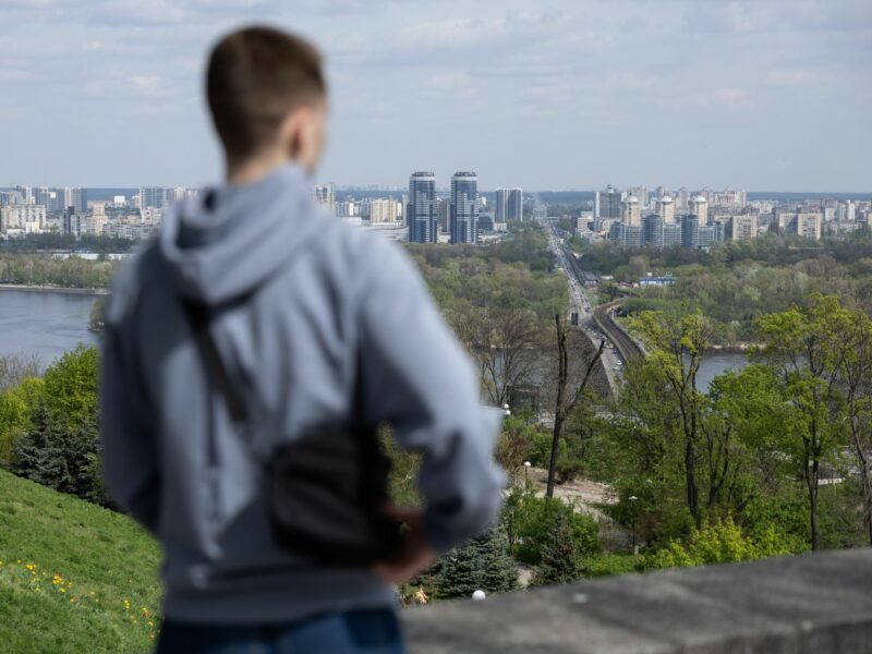 Photo of a man looking over the city of Kyiv in Ukraine.