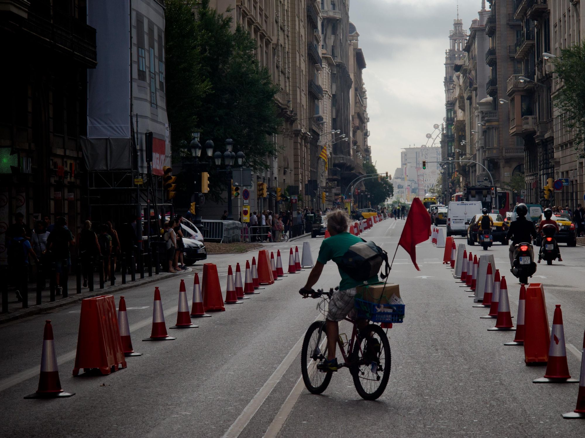 Photo of a man riding a bicycle in a lane reserved for cyclists.