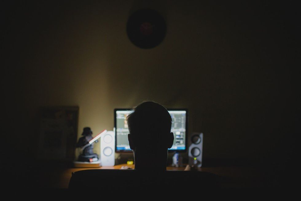 Photo of a man sitting in front of a computer.
