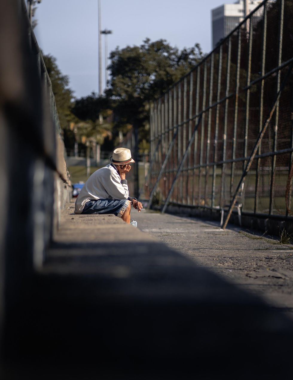 Photo of a man sitting on a concrete bench in Rio de Janeiro, Brazil