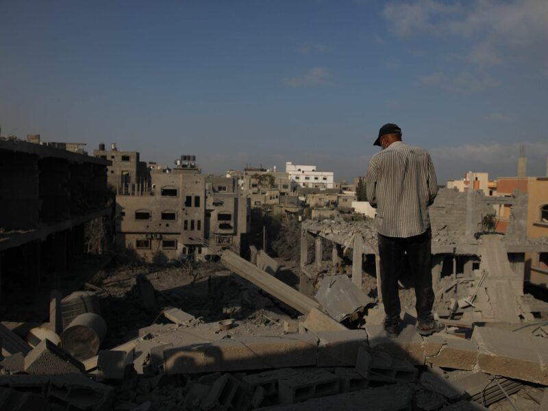 Photo of a man standing amid rubble after an Israeli airstrike hit a refugee camp in central Gaza.