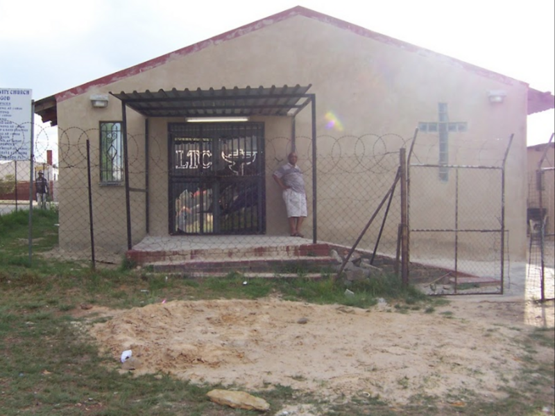 Photo of a man standing in front of the Living Trinity Church in Westbury, Johannesburg