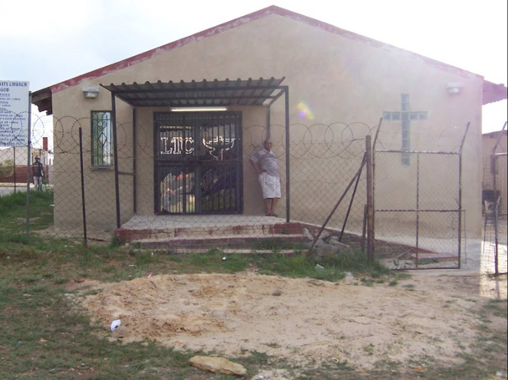Photo of a man standing in front of the Living Trinity Church in Westbury, Johannesburg