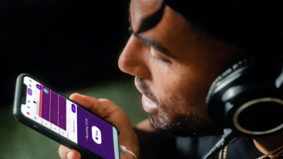 photo of a man talking into his smartphone