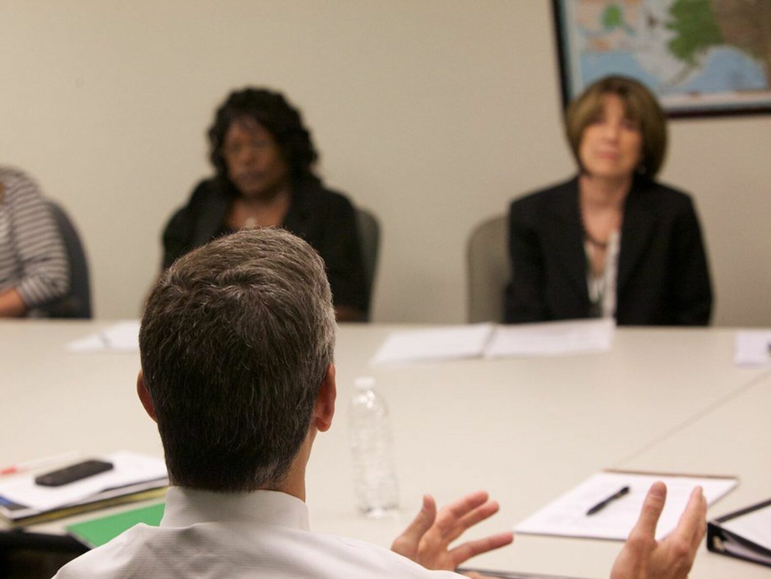 photo of a man talking to three women across a table