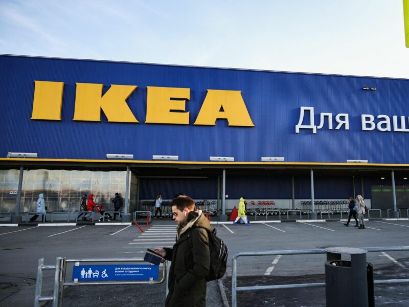 photo of a man walking in front of Ikea store