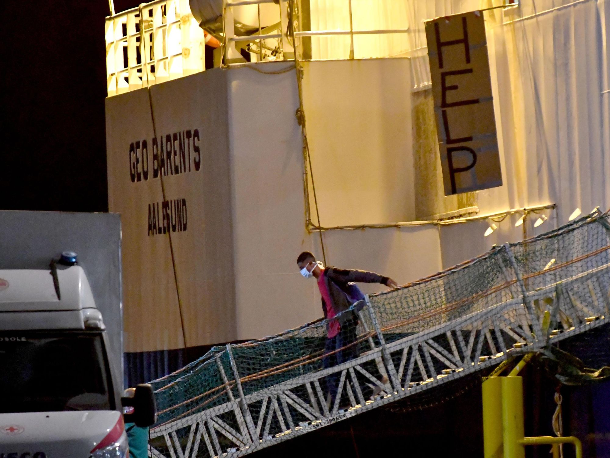Photo of a man walking on a plank off a ship