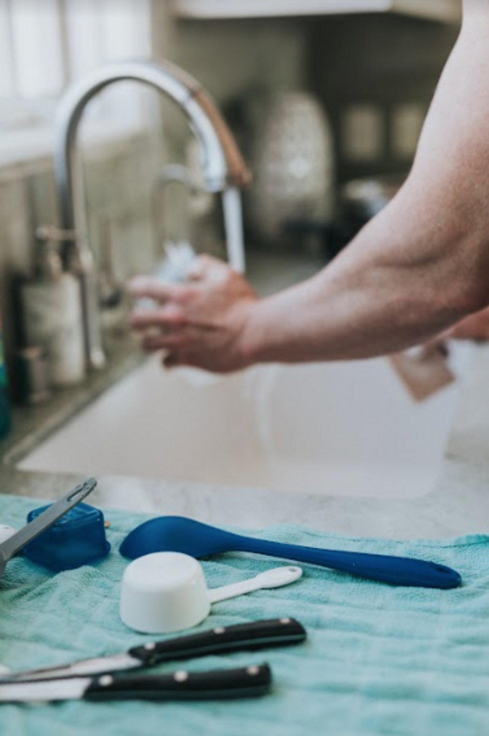 Photo of a man washing dishes