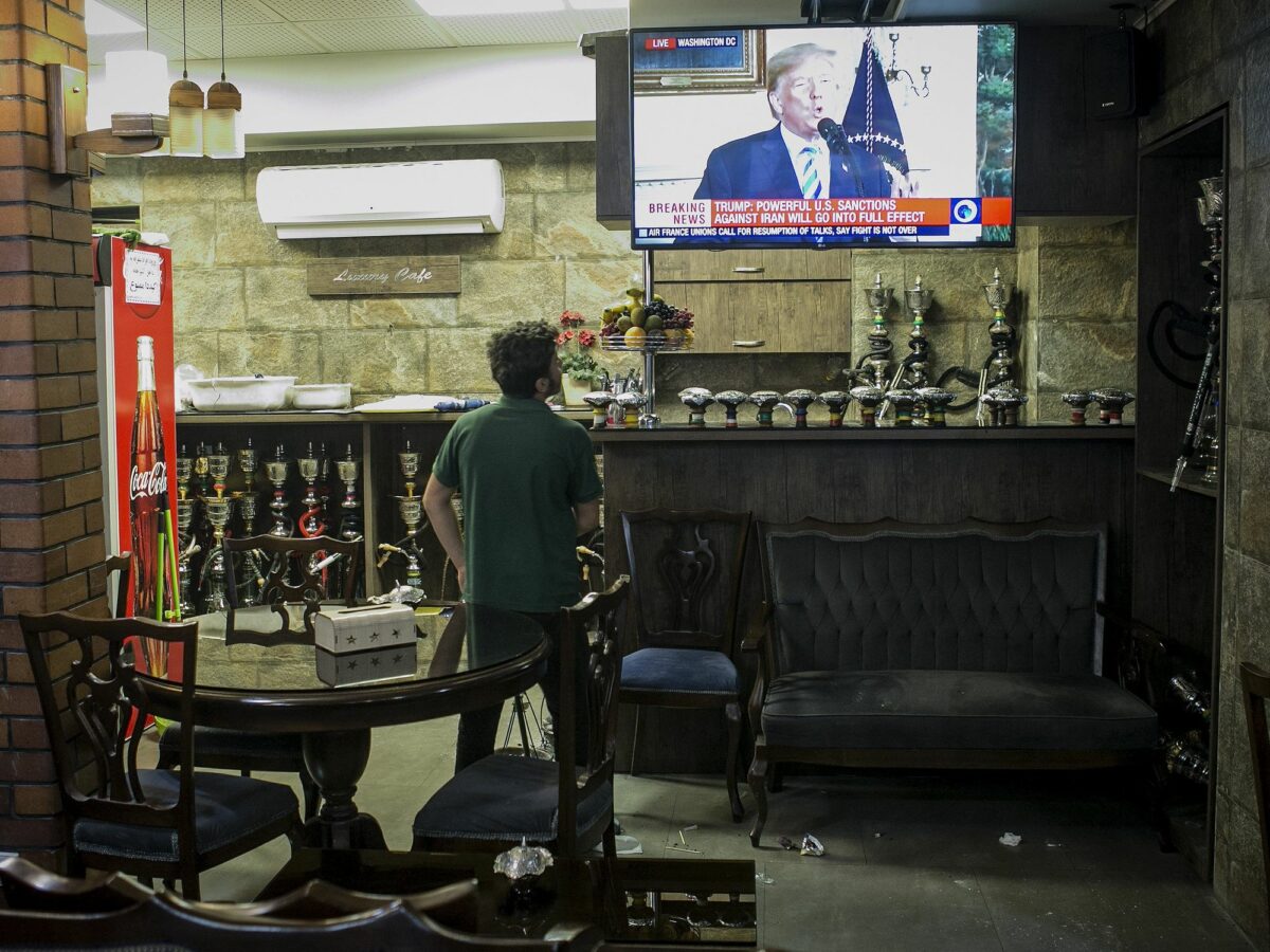 Photo of a man watching the news broadcast on U.S. withdrawal from the Iran nuclear deal at a teahouse in central Tehran, Iran, in 2018