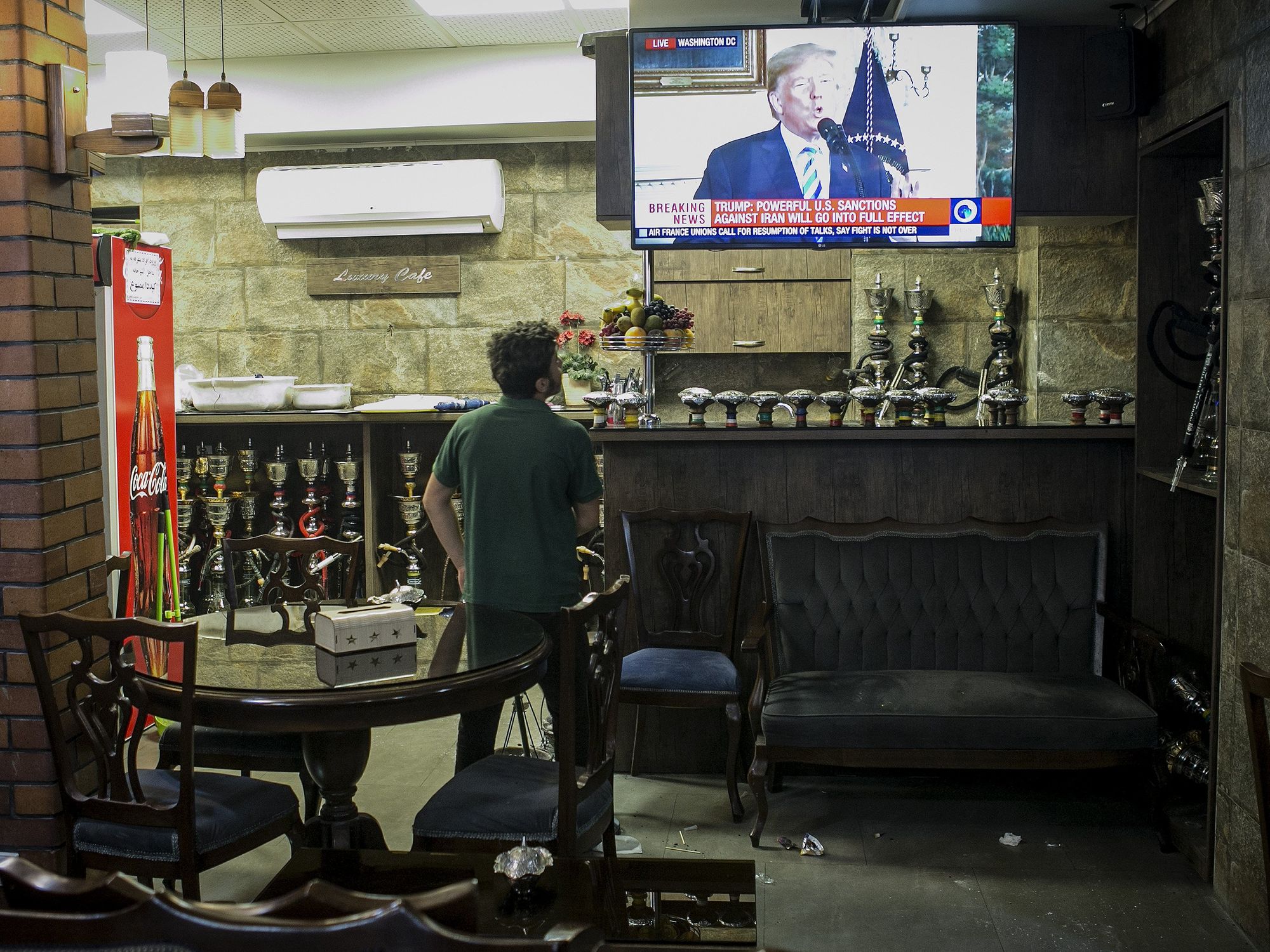 Photo of a man watching the news broadcast on U.S. withdrawal from the Iran nuclear deal at a teahouse in central Tehran, Iran, in 2018