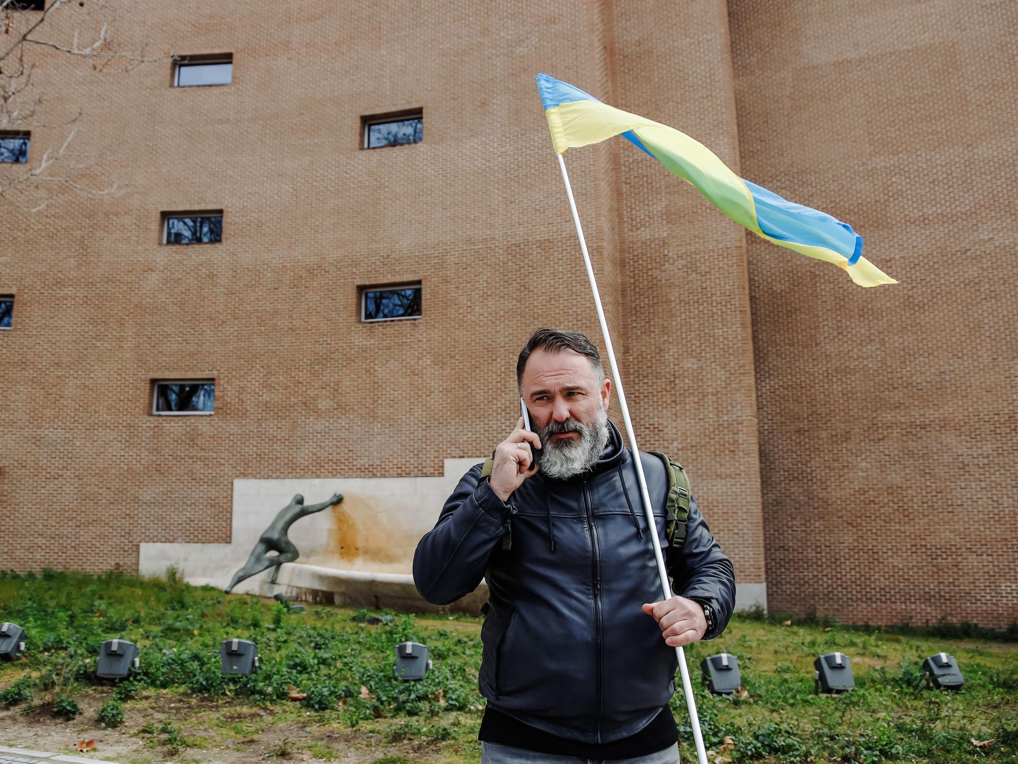 photo of a man with a beard holding a ukrainian flag