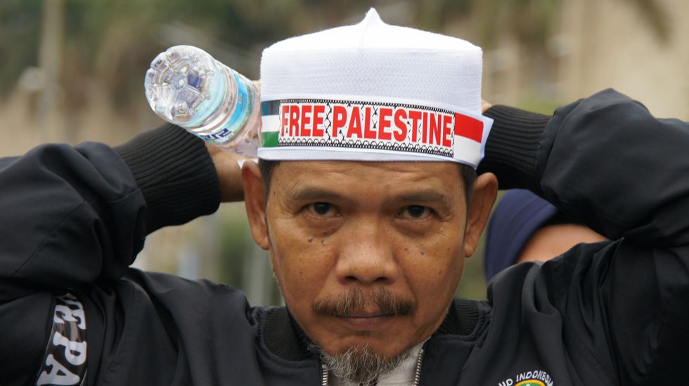 photo of a man with a Free Palestine headband