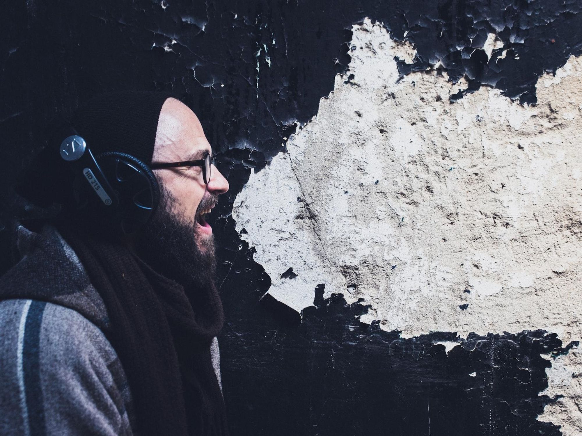 photo of a man yelling with white paint in background