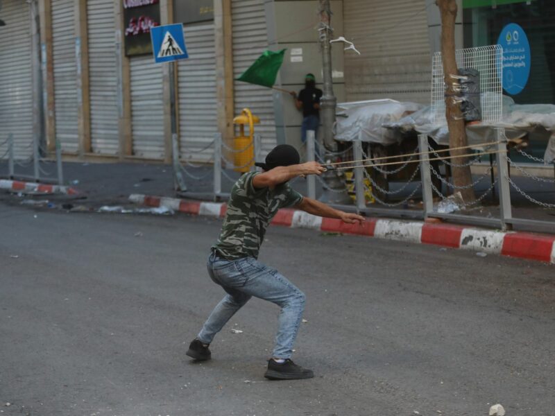Photo of a masked man using slingshot