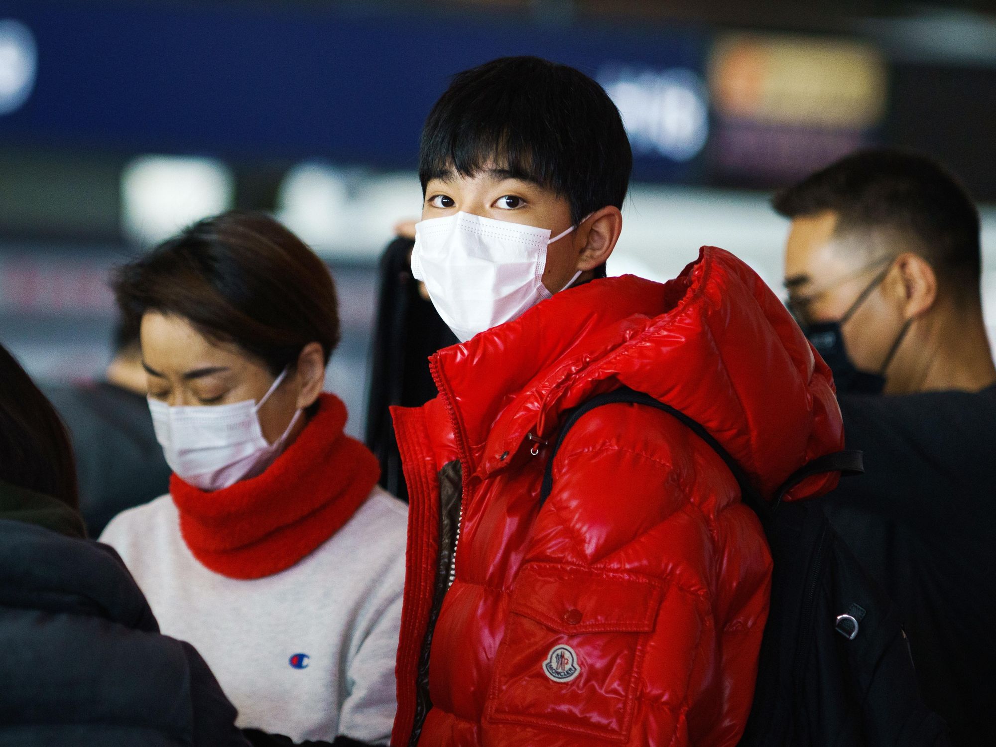 photo of a mother and son at beijing airport with masks