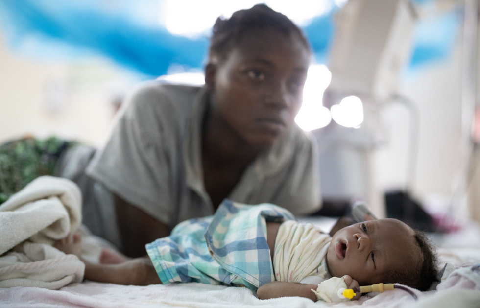 Photo of a newborn baby in the hospital attached to an IV