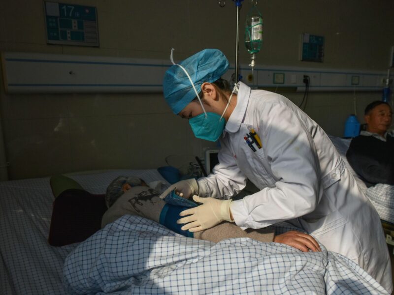 Photo of a nurse treats patients infected with COVID-19 at a hospital in Fuyang City, China, on Jan. 4, 2023.