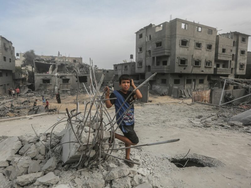 Photo of a Palestinian child near destroyed buildings in Gaza