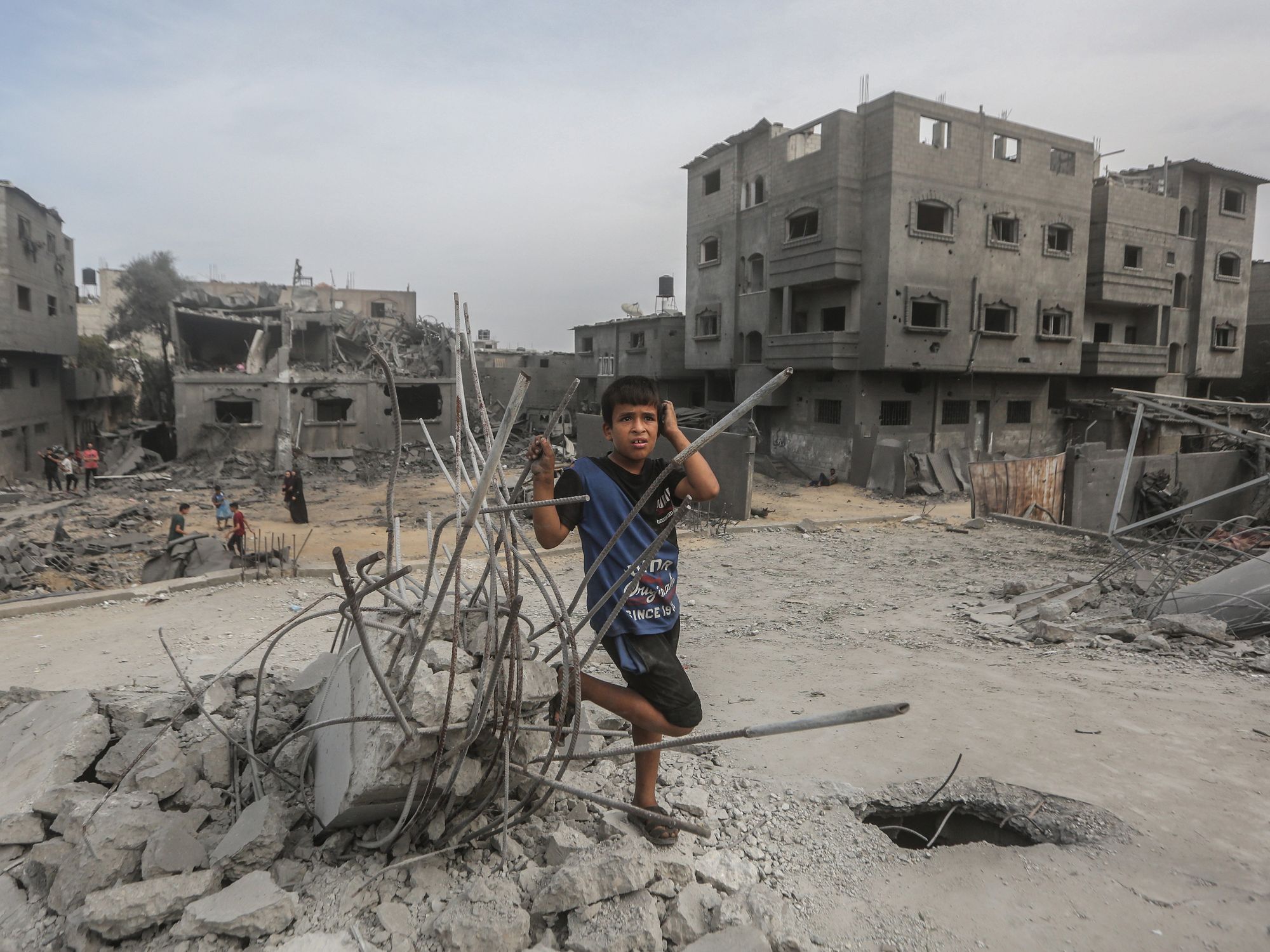 Photo of a Palestinian child near destroyed buildings in Gaza