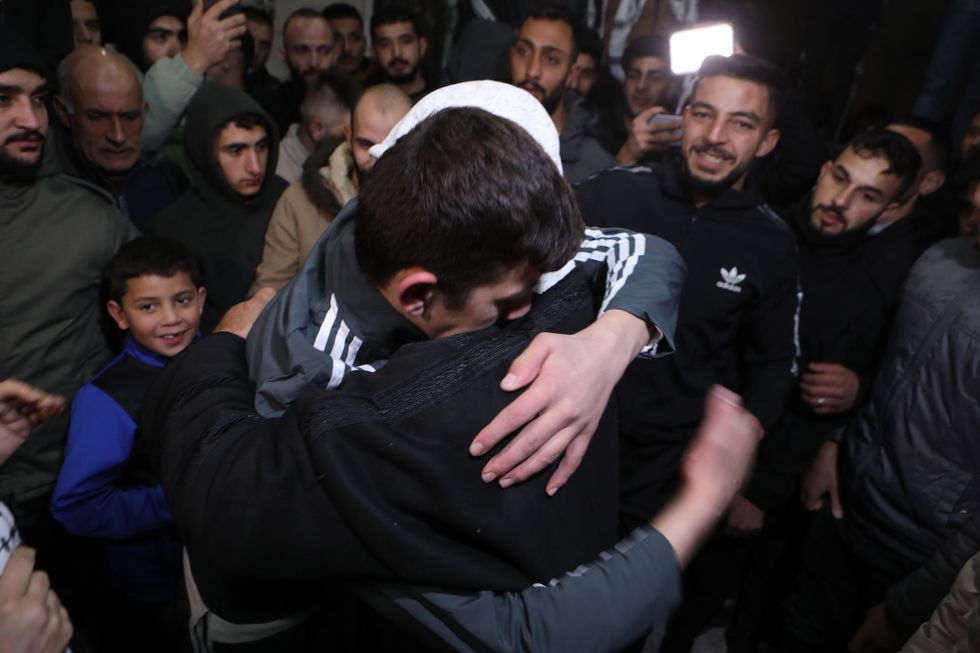 Photo of a Palestinian prisoner hugging a relative after being released from an Israeli jail in exchange for Israeli hostages released by Hamas from Gaza on Nov. 27.