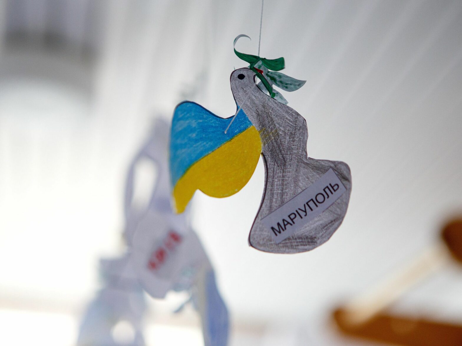 Photo of a paper dove reading "Mariupol" at a shelter of the Ya Dopomozhu NGO center for displaced children in Uzhhorod, western Ukraine.