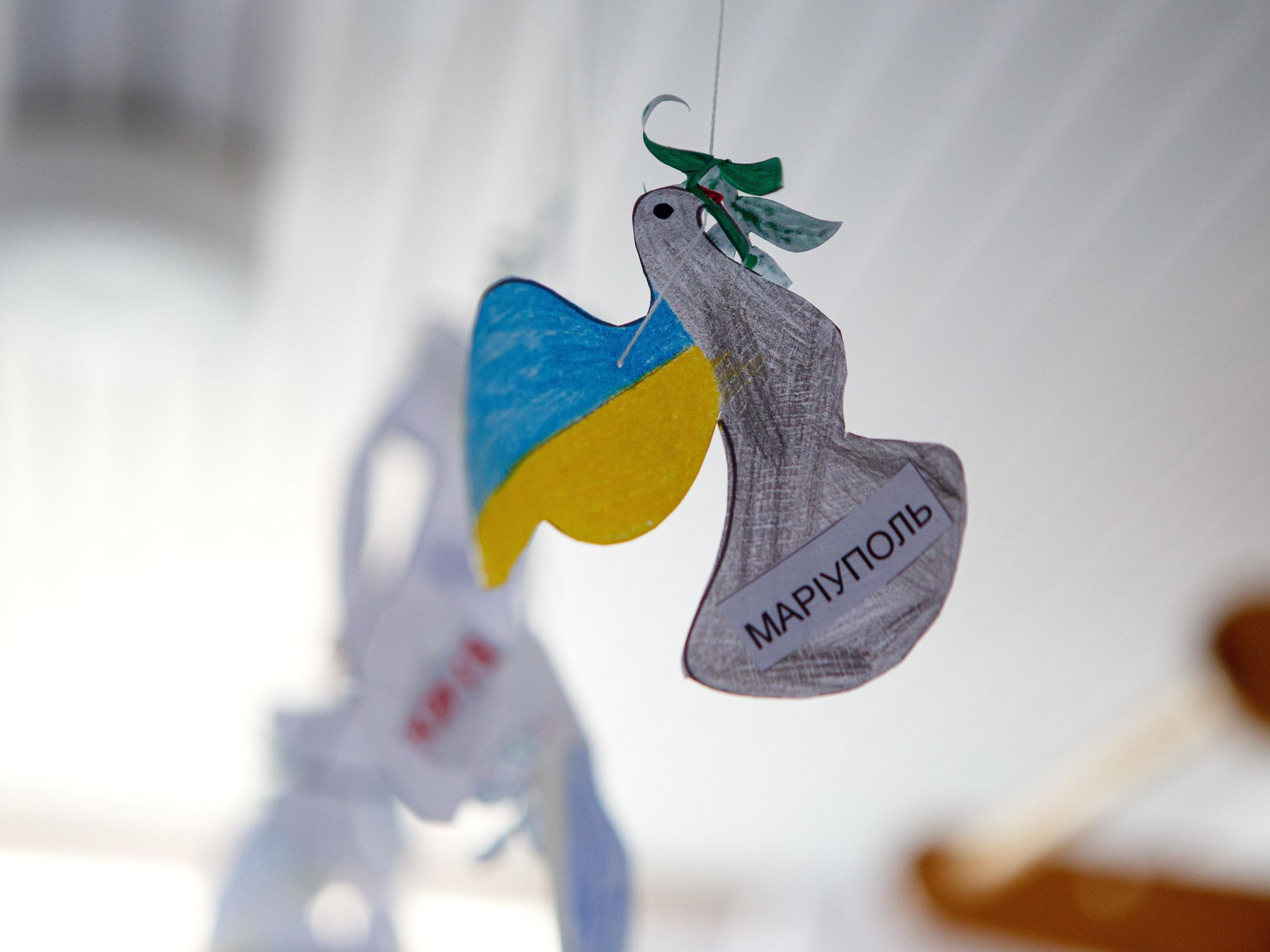 Photo of a paper dove reading "Mariupol" at a shelter of the Ya Dopomozhu NGO center for displaced children in Uzhhorod, western Ukraine.