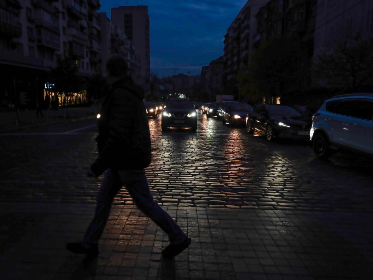 Photo of a pedestrian crossing the street during blackout