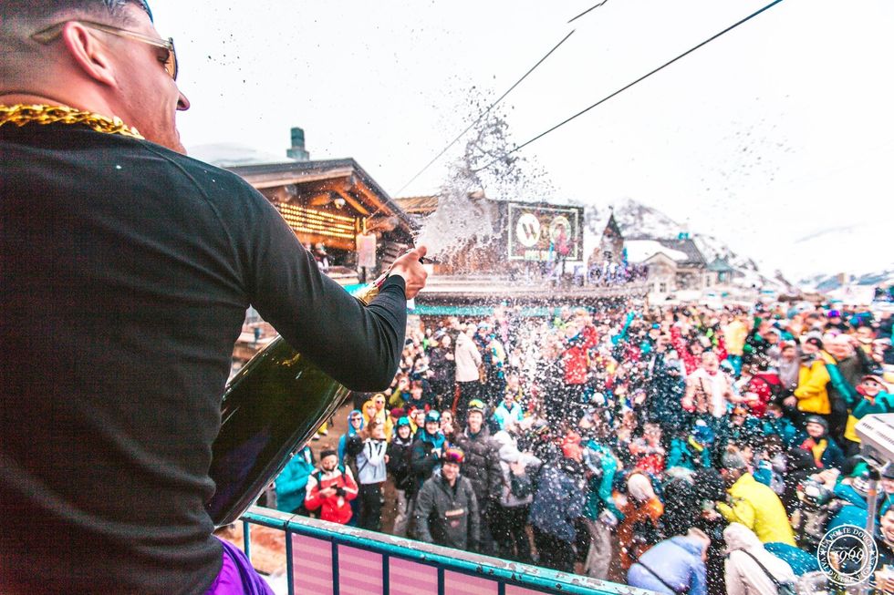 Photo of a performer at restaurant/bar La Fruitière sprays champagne over the crowd at La Folie Douce Val d'Isère, France, Jan. 27, 2020.