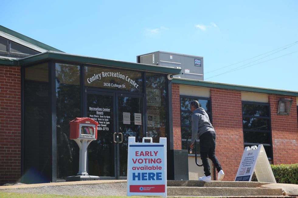 Photo of a person entering a voting center in in Atlanta, Georgia.