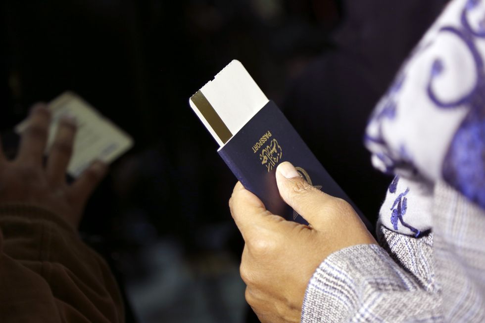 Photo of a person holding a passport at Sanaa's International Airport, Yemen