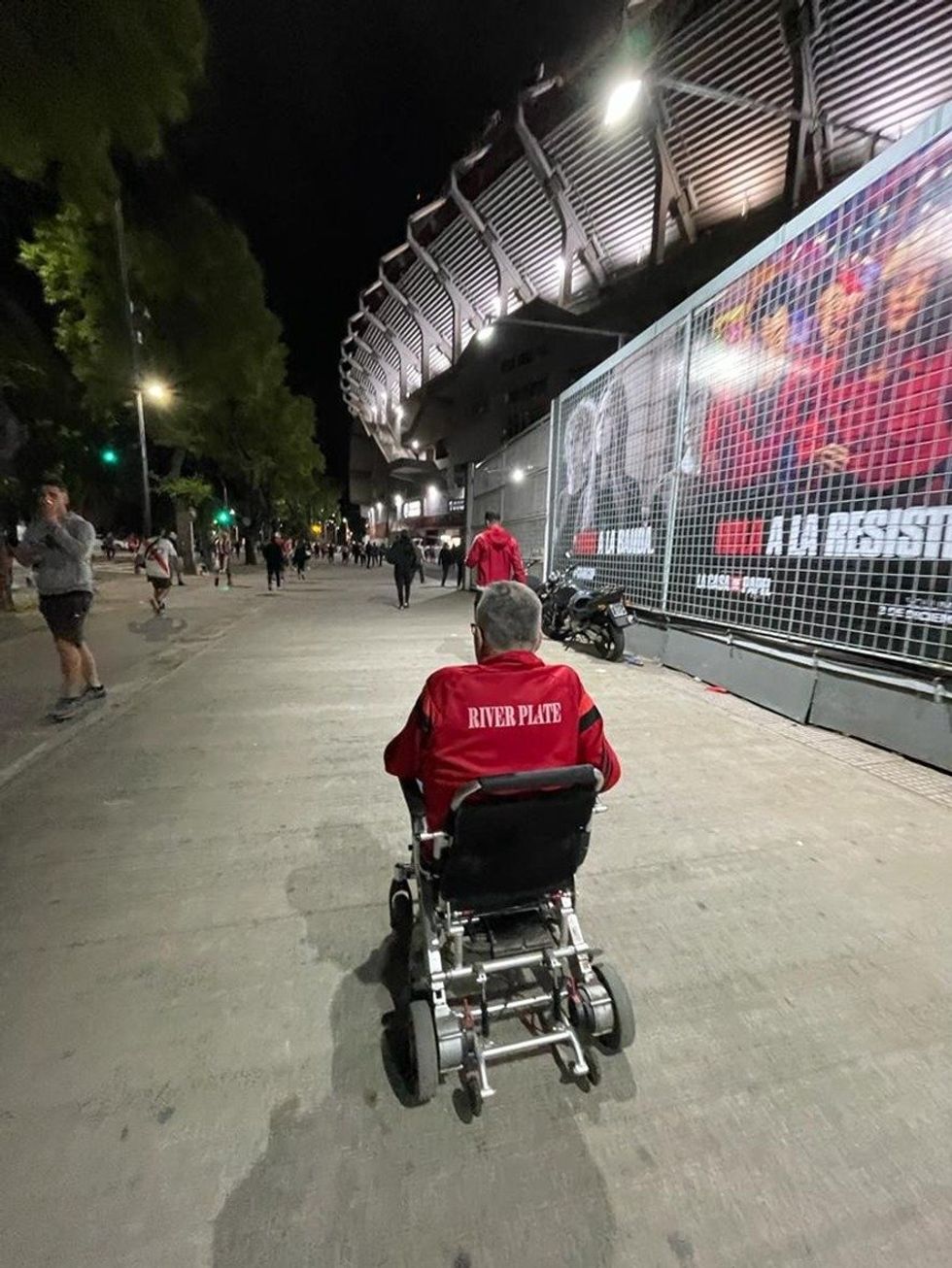 Photo of a person in a wheelchair attending a game.