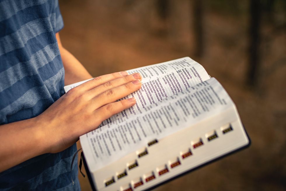 Photo of a person reading a Bible