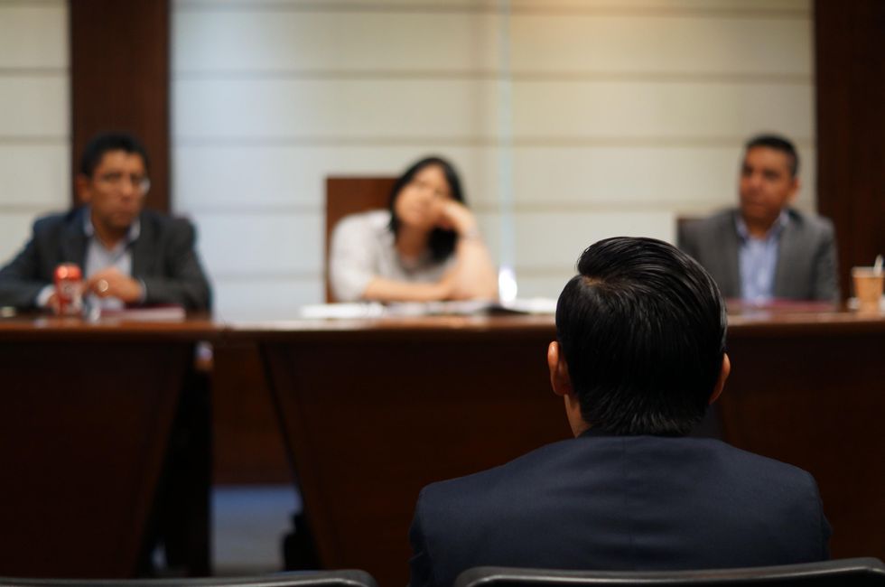 Photo of a person sitting in front of a jury