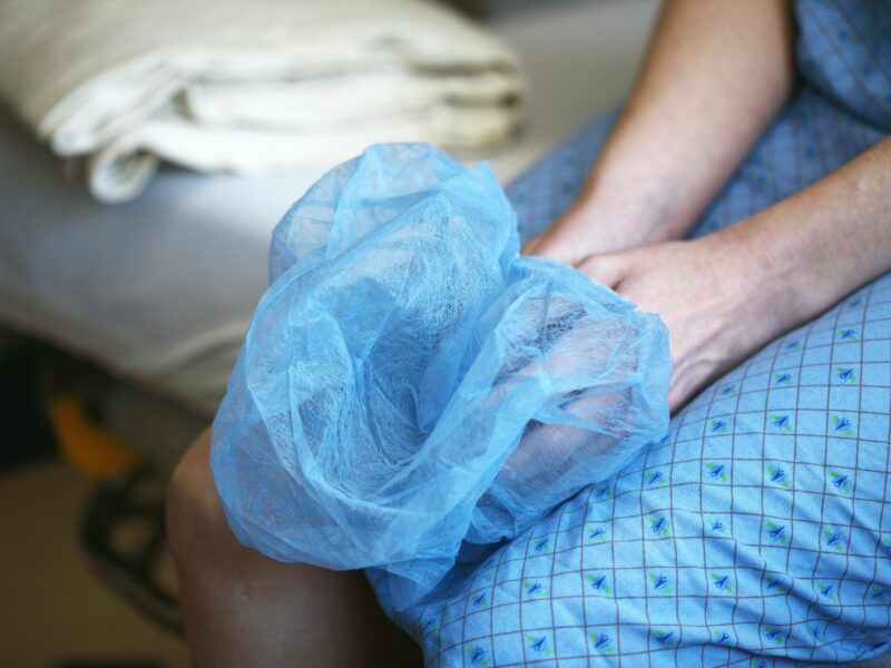 Photo of a person sitting on a hospital bed