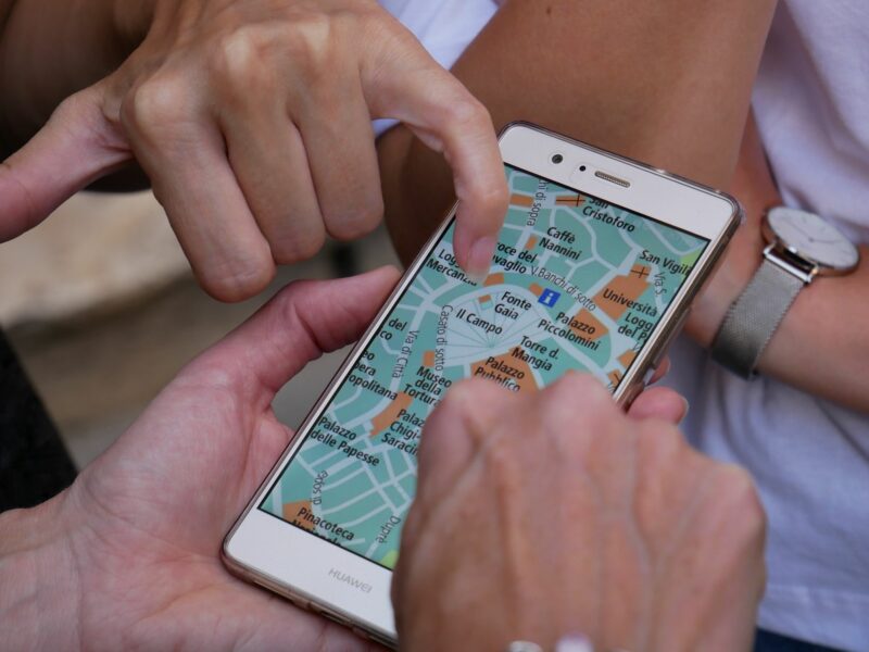 Photo of a person touching a map on smartphone.