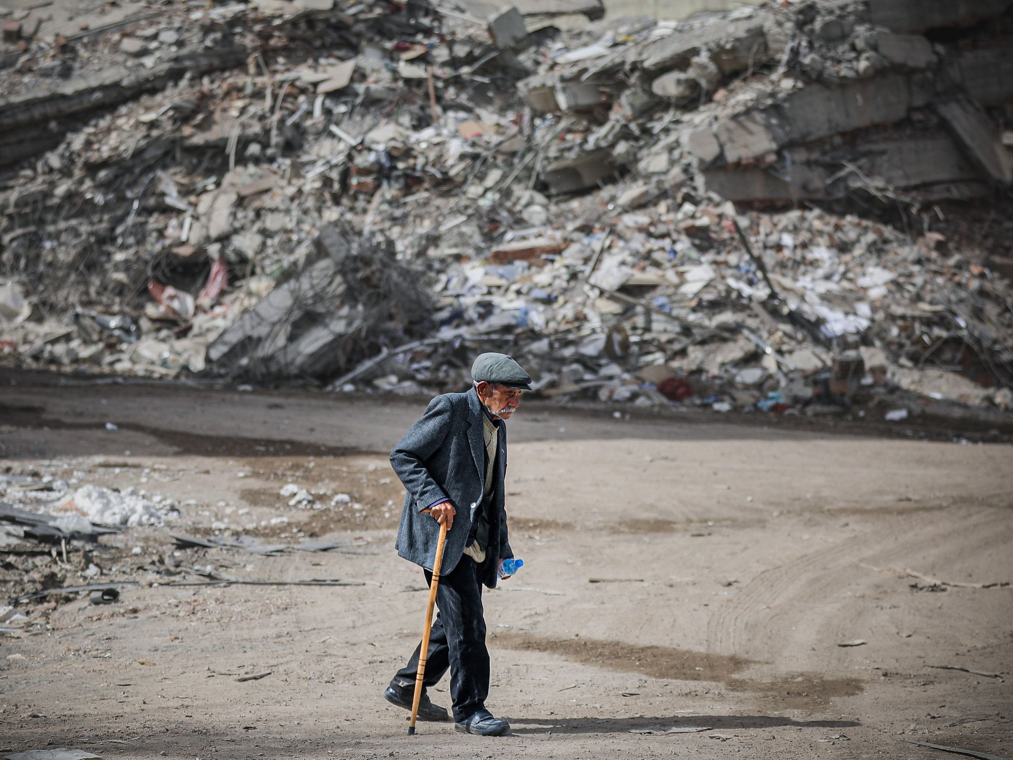Photo of a person walking in the aftermath of Turkey's earthquake