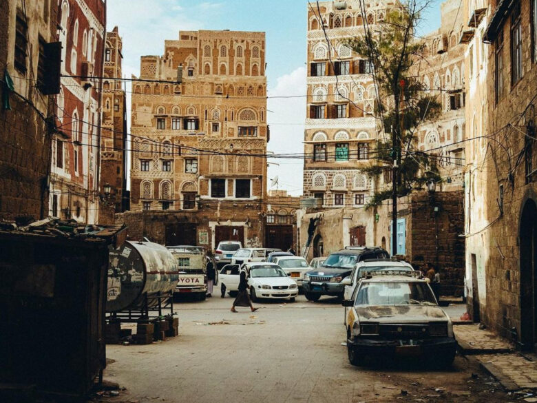 Photo of a person walking in the streets of Sanaa's historical center