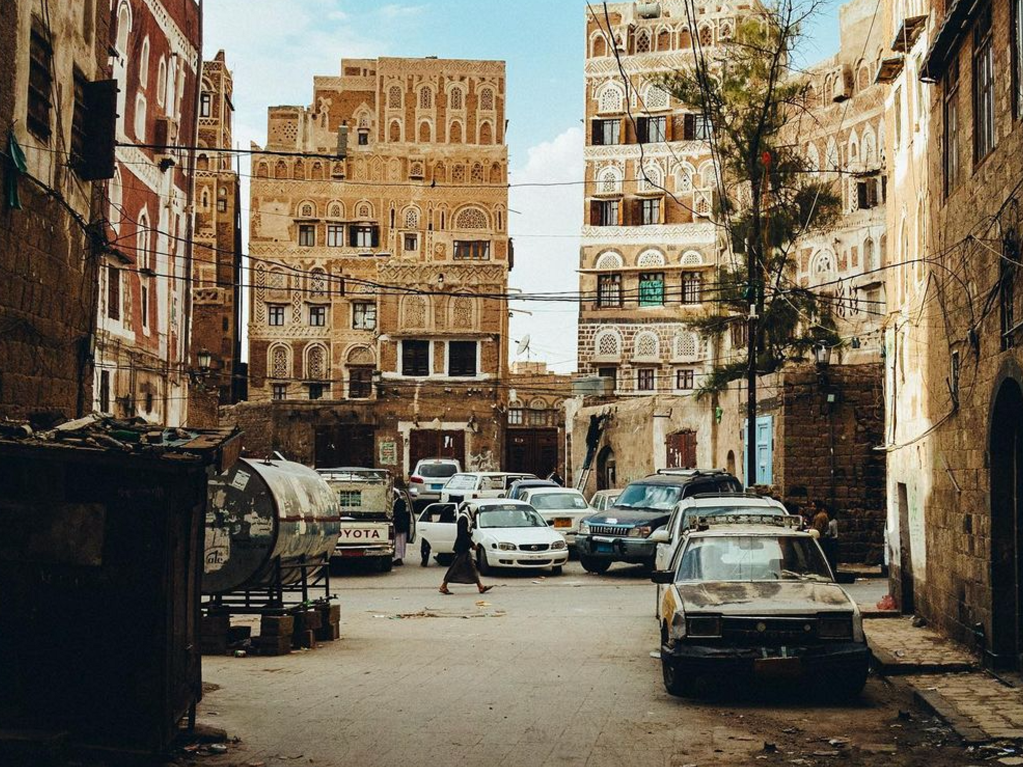 Photo of a person walking in the streets of Sanaa's historical center