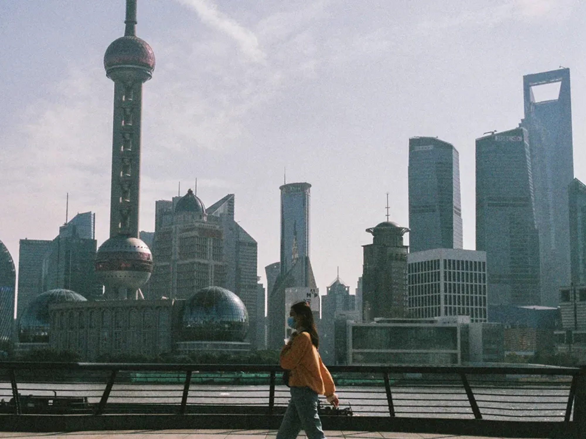 Photo of a person walking in the streets of Shanghai with a mask during the pandemic