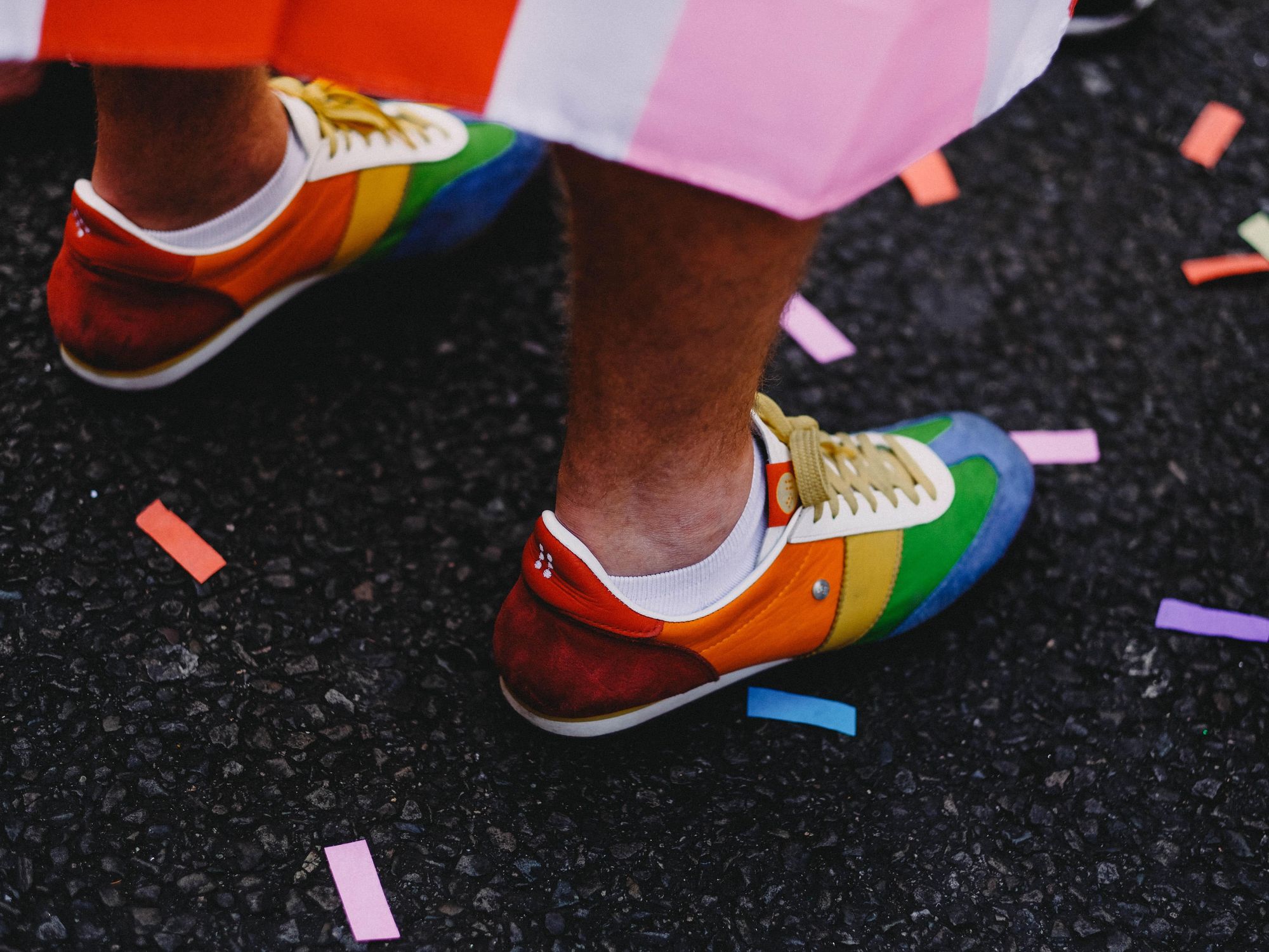 Photo of a person wearing rainbow-colored shoes