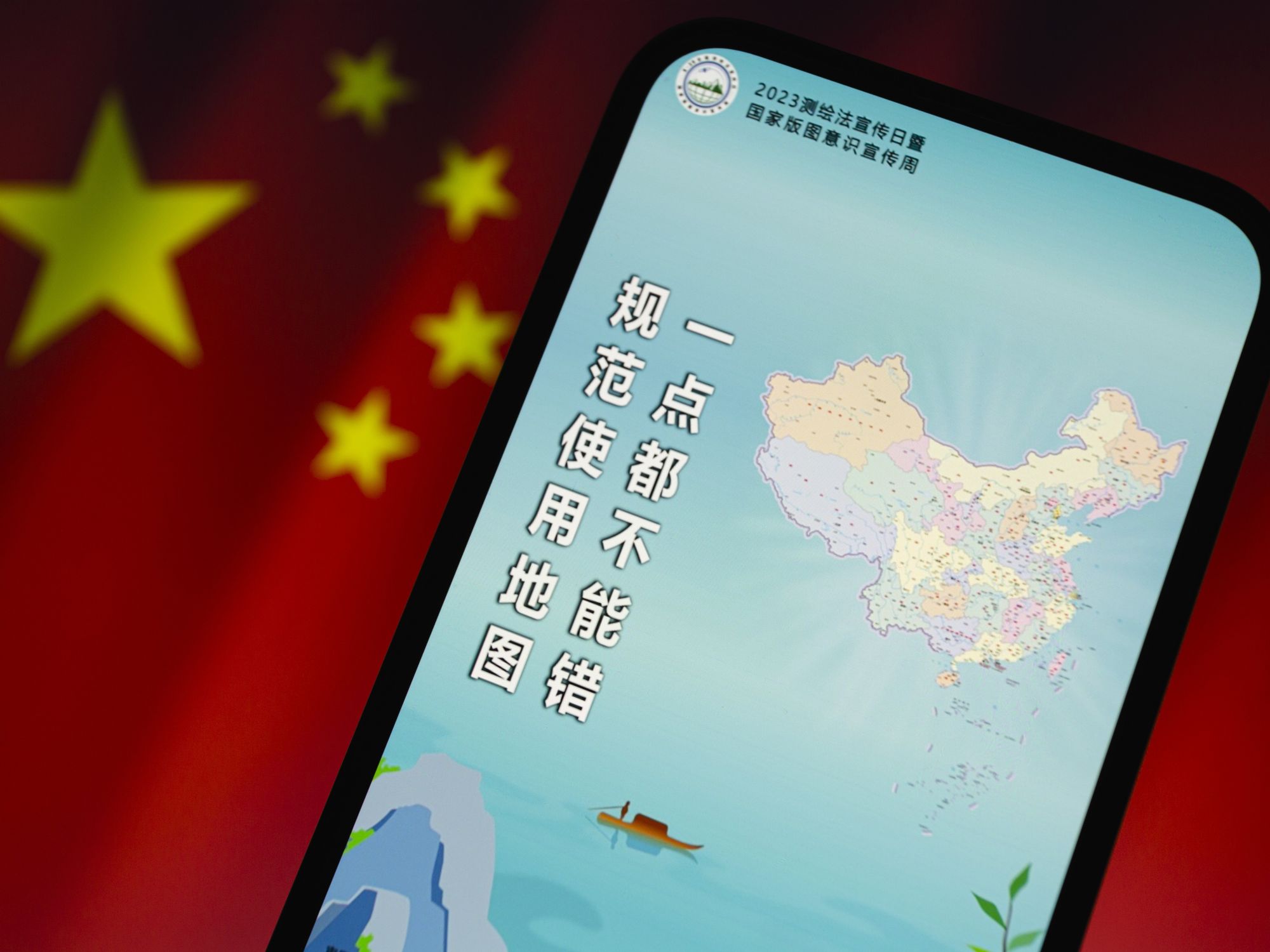 Photo of a phone showing the new controversial map of China, with a Chinese flag as a backdrop