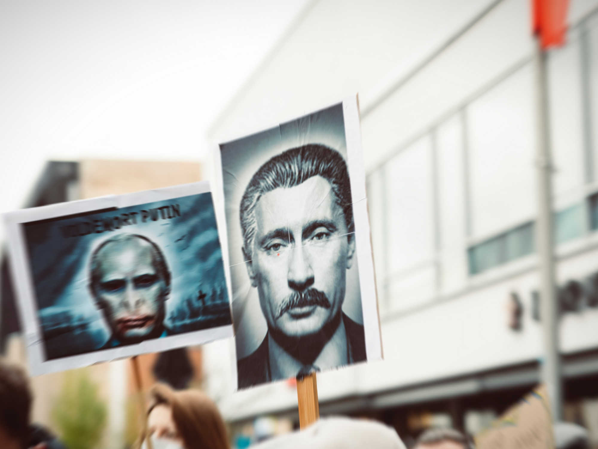 Photo of a placard during an anti-Putin protest, showing a mashup photo of Putin and Stalin