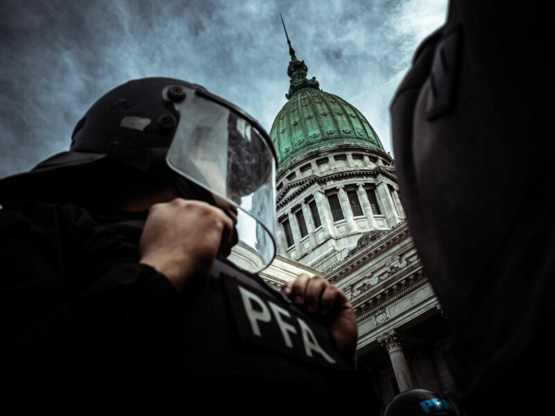 Photo of a police officer in front of the National Congress during the march against retirement law veto in Buenos Aires, Argentina.