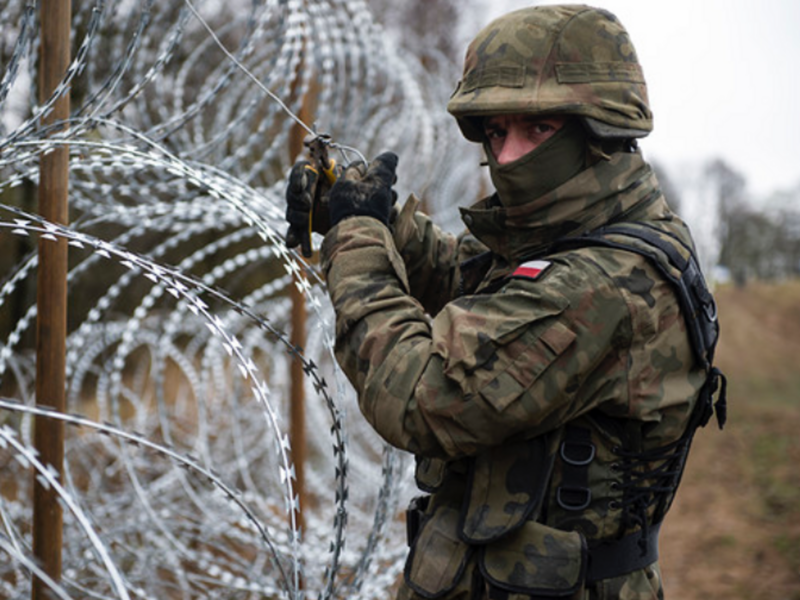 Photo of a Polish soldier seen working at the construction of the fence along the border with the Russian exclave of Kaliningrad.
